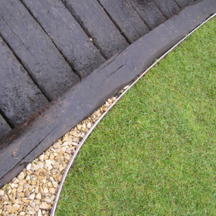 Straight Edge Close-Up With Grass And Deck